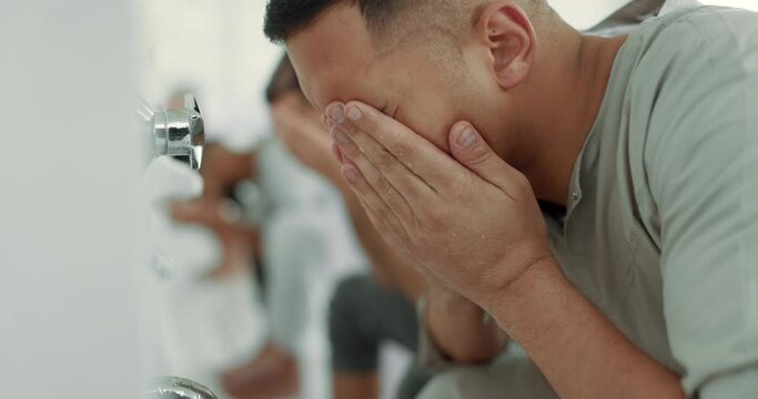 Muslim, religion and men washing face for prayer in bathroom for purity, and cleaning ritual. Islamic, worship and faith of group of people with wudu together at a mosque or temple for holy practice
