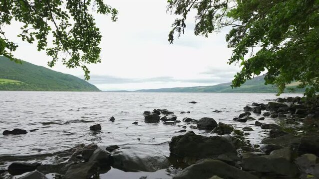 Shore of Loch Ness in Scotland, full of vegetation and trees, lake famous for its monster Nessi.