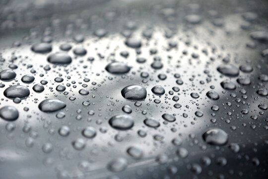 Water drops collect on top of metallic car surface, Rain droplets, circular liquid