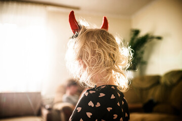 pint-sized imp with devilish horns this Halloween