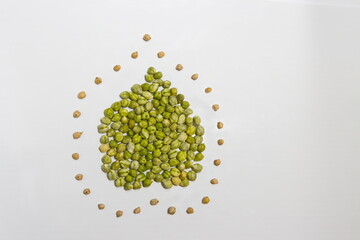 Chickpeas on a white background. Flat lay. The freshly harvested seeds are arranged in the shape of...