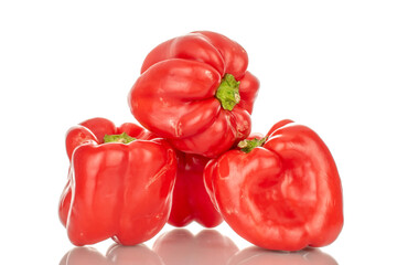 Four red sweet peppers, macro, isolated on white background.