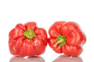 Two red sweet peppers, macro, isolated on white background.