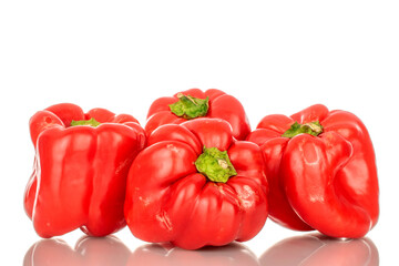 Four red sweet peppers, macro, isolated on white background.