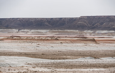 Hills of chalk and limestone and slopes of multi-colored mountains with weathering and washouts from water, colored relief in the steppe