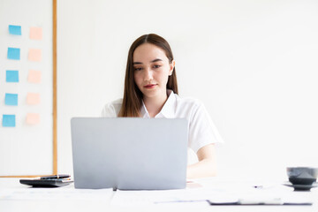 Asian businesswoman sit at their desks and calculate financial graphs showing results about their investments, planning a successful business growth process