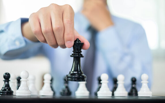 hand of businessmen moving chess in competition shows leadership, followers and business success strategies