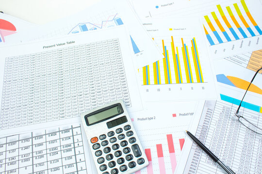 Financial printed paper charts, graphs and diagrams on the table. Top view
