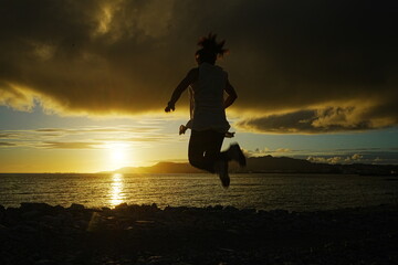 Woman Jumping on the Sunset Beach in Nago, Okinawa, Japan - 日本 沖縄 名護 東江ビーチ...