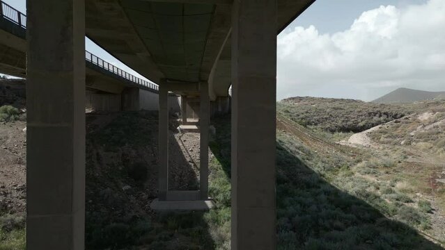 drone passage under concrete modern bridge over canyon, Tenerife, 4k footage 