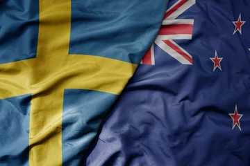 Foto op Aluminium big waving national colorful flag of sweden and national flag of new zealand . © luzitanija