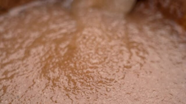 Preparation of a health beverage from psyllium husk mixed with water. Stirring jelly drink with a spoon. Macro shot