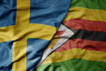 Fototapeta premium big waving national colorful flag of sweden and national flag of zimbabwe .