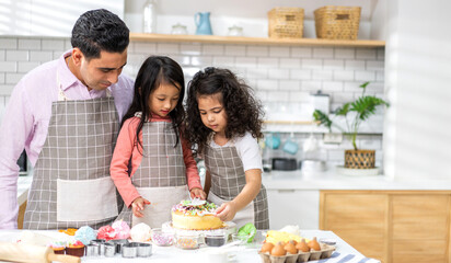 Portrait of enjoy happy love asian family father and little toddler asian girl daughter child having fun cooking together with dough for homemade bake cookie and cake ingredient on table in kitchen