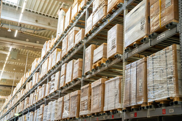  Long shelves with many cardboard boxes with product in warehouse of IKEA 