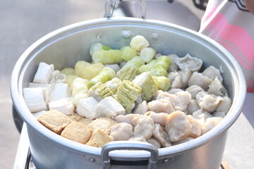 dumplings sellers, street vendors. seller of snacks for dumplings, egg dumplings, potatoes, sticks, cabbage and peanut sauce.