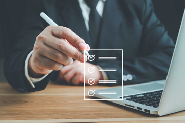 Business performance checklist, Quick checklist and clipboard management concept, job applicants, businessman using laptop doing online checklist survey,Employees must complete the online survey form.