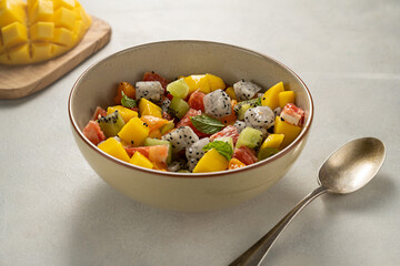 Exotic fruit salad with fresh mango, dragon fruit, grapefruit, kiwi.