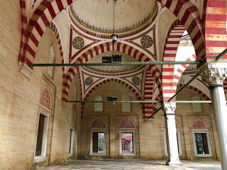 In terms of perspective, the stone arched domed mosque in the marble courtyard, shot from the ground and in focus, offers an aesthetic and historical view.