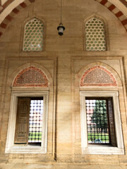 Looking at the green nature with longing and hope through the iron-barred window reflects inner peace and the beauty of nature.