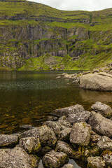 Coumshingaun Lough with rocks and vegetation