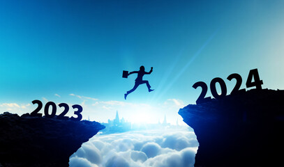 Silhouette of a man jumping from 2023 to 2024. 2024 New Year concept. New year's card 2024,