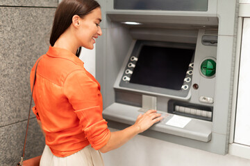 Bank Client Woman Using ATM Machine For Money Withdrawal Outdoor