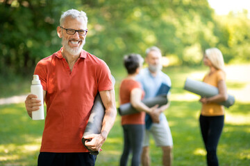 Fototapeta premium Handsome Senior Man Posing Outdoors During Group Sport Training