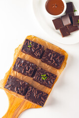 Delicious chocolate brownies with mint on white background. Sweet cake concept. 