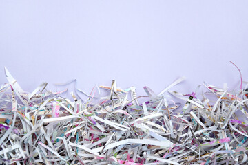The shredded paper on light pink background.