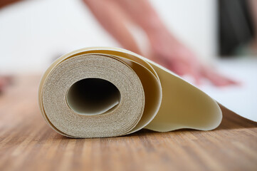 Close-up of a white roll of wallpaper.