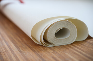 Close-up of a white roll of wallpaper.