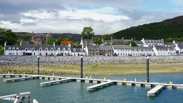 Panoramic view of the coastal town of Ullapool with its typical white houses and docks to dock boats, Scotland.