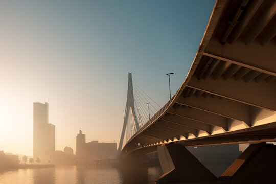 The Erasmusbrug in Rotterdam on a warm early morning in a misty sunrise