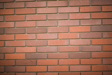 Background - a wall of red-brown clinker bricks