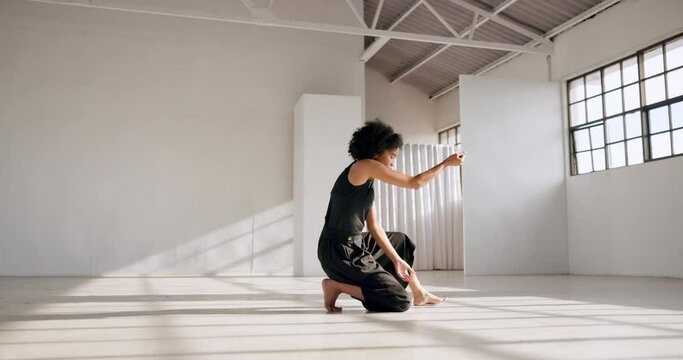 Dance performance, fitness and a woman in a creative art studio with energy and passion. African contemporary dancer practice for theater, sports and freedom with balance, exercise and talent