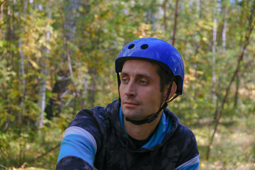A cyclist in gear has stopped and is looking around in the woods.Active lifestyle