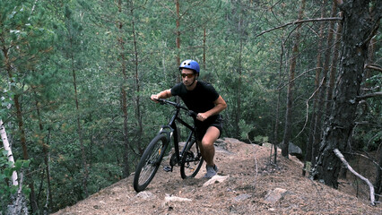 cyclist in a protective helmet climbs the mountainous terrain with a bicycle.Active lifestyle