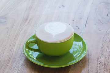 Cup of cappuccino coffee on wooden table