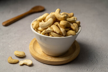 Cashew nuts in a small bowl. Healthy food snack. 