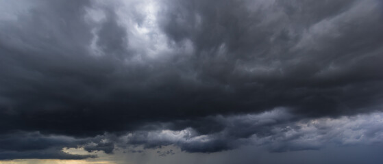 The dark sky with heavy clouds converging and a violent storm before the rain.Bad or moody weather...