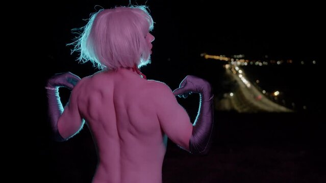Drag queen with bare back throws off her dress and turns around