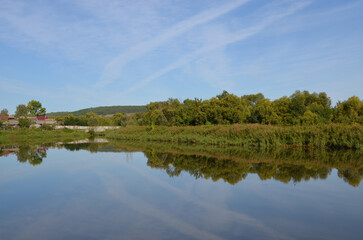 Summer landscapes. Reflection in the pond.