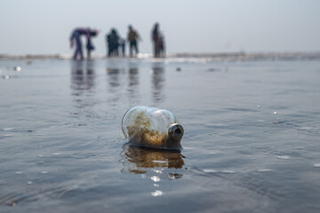 empty bottle on the beach sand 