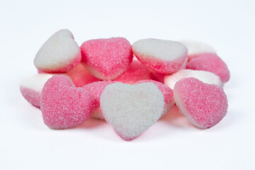 Obraz na płótnie Canvas pile of heart shaped sugar Candies on white background