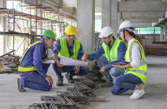 engineer project manager inspecting the structural standards of new building construction,engineers team in safety uniform working outside office in the building under construction site