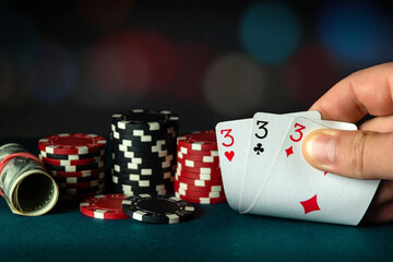 Poker cards with three of a kind or a set combination. The player hand holds a winning combination...