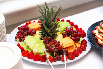 fruits, tomatoes, cheese, and charcuterie on a platter, symbolizing a delectable and balanced culinary experience