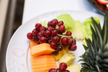 fruits, tomatoes, cheese, and charcuterie on a platter, symbolizing a delectable and balanced culinary experience