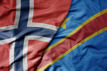 big waving national colorful flag of norway and national flag of democratic republic of the congo .